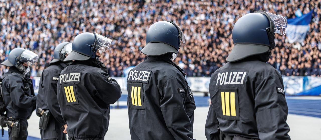 Polizisten stehen vor der Fankurve im Olympiastadion