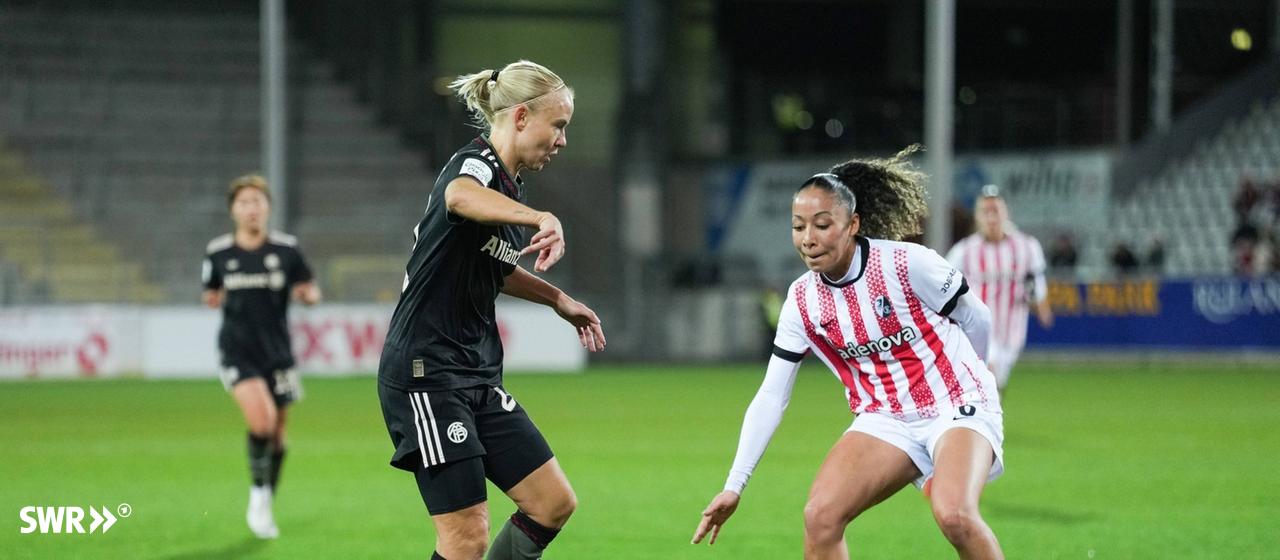 Pernille Harder (FC Bayern München) im Zweikampf mit Nicole Ojukwu (SC Freiburg).