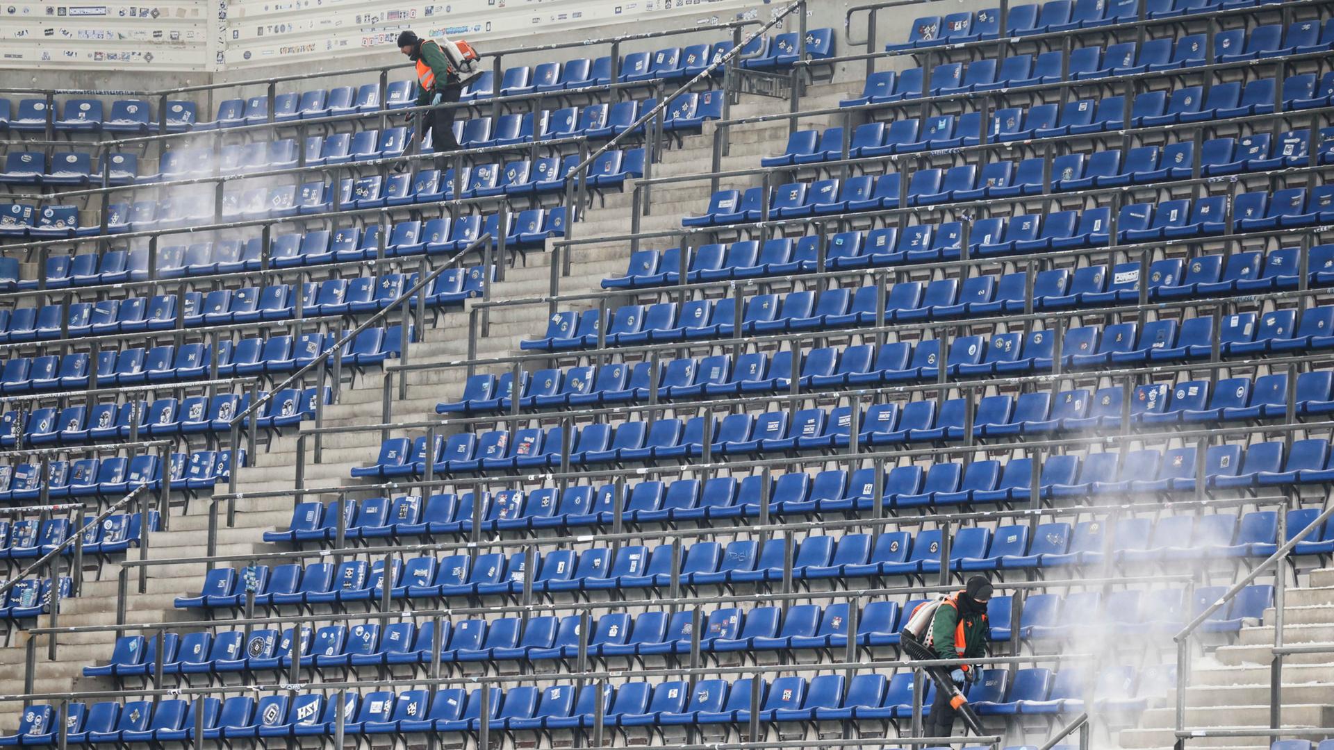 Ränge im Volksparkstadion werden vom Schnee befreit. | Christian Charisius/dpa