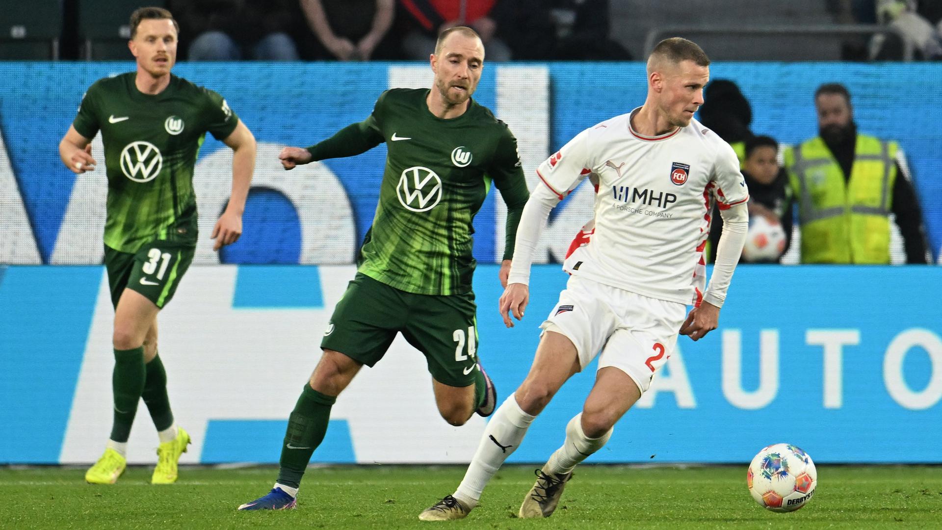 Wolfsburgs Christian Eriksen (l.) gegen Heidenheims Adrian Beck | dpa